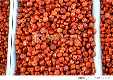 Red beads in white trays close up 140547782