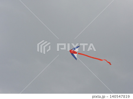 Colorful kite flying in a cloudy sky Colorful kite flying in a cloudy sky 140547819