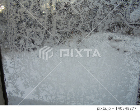 Beautiful frost paint on a glass window in winter. 140548277