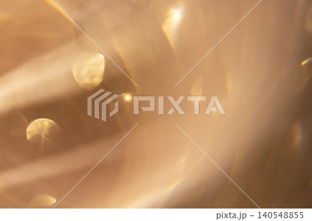 Abstract close-up of soft golden light reflections and blurred shapes creating a dreamy atmosphere with circular bokeh effects and gentle gradients Abstract close-up of soft golden light reflections and blurred shapes creating a dreamy atmosphere with circular bokeh effects and gentle gradients 140548855