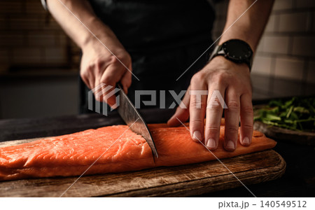 Chief hands preparing salmon fillet Chief hands preparing salmon fillet 140549512