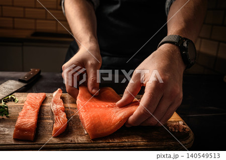 Chief cooking salmon red fish fillet in the kitchen 140549513