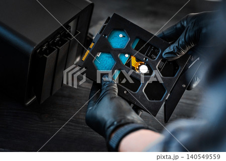 Technician Hands Inserting Hard Disk Drive Into Nas Server Bay During Maintenance Technician Hands Inserting Hard Disk Drive Into Nas Server Bay During Maintenance 140549559