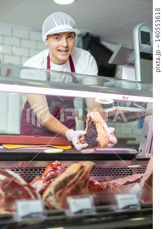 Male meat vendor provides selection Male meat vendor provides selection 140553618
