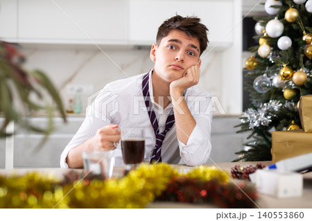 man suffering while hungover after new year party 140553860