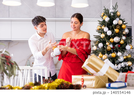 Young couple preparing to celebrate in home Christmas and New Year 140554146