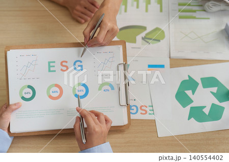 Two people analyzing ESG sustainability data and recycling report Two people analyzing ESG sustainability data and recycling report 140554402