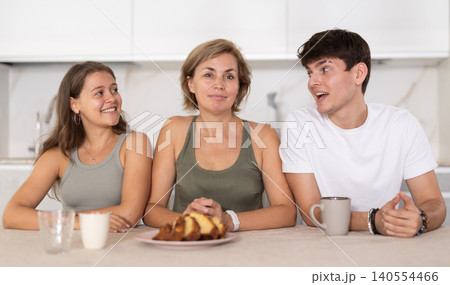 Girl and guy have nice conversation with woman, mom, during Sunday tea party 140554466