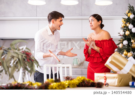 Conflict of a married couple during Christmas holiday - husband and wife yell at each other 140554480