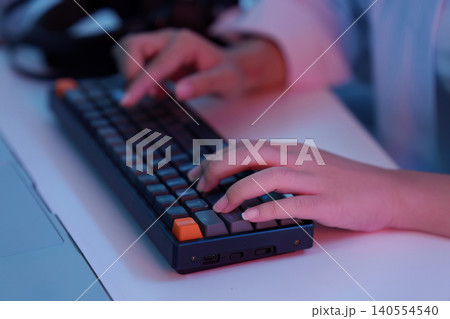 Close up of hands typing on mechanical keyboard for gaming technology and computer work productivity Close up of hands typing on mechanical keyboard for gaming technology and computer work productivity 140554540