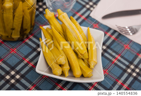 Pickled okra pods on plate, homemade preserves 140554836