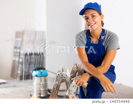 Portrait of a young woman worker in uniform Portrait of a young woman worker in uniform 140554948
