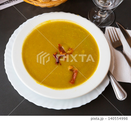 Cream soup of vegetables garnished with gammon slices 140554998