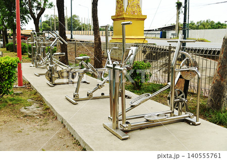 A variety of stainless steel exercise equipment is available for users to enjoy in Bang Sai Park, a local public park. 140555761
