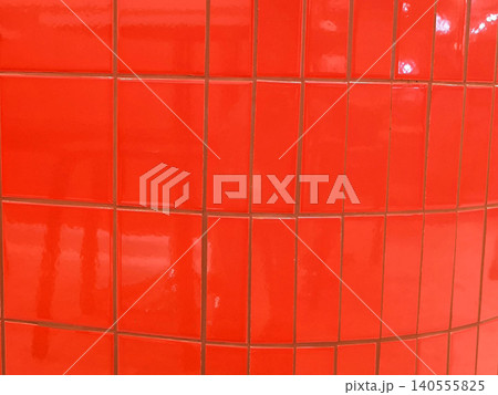 Bright Red Glossy Square Tiles  on a wall surface 140555825