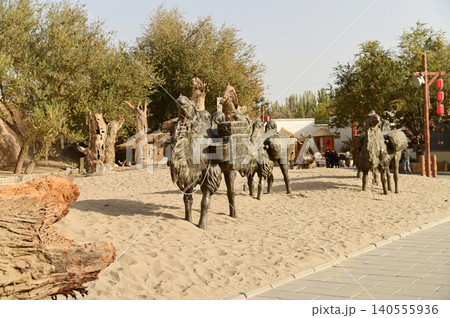 The ancient metal caravan of camels statues transporting goods in the desert of Kuche city on the Silk Road and the enchanting city of Aksu. 140555936