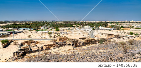 A panoramic view of the ancient Shanqal Fort ruins on a rocky hill overlooking a lush palm oasis and the town of Turbah, Saudi Arabia. A panoramic view of the ancient Shanqal Fort ruins on a rocky hill overlooking a lush palm oasis and the town of Turbah, Saudi Arabia. 140556538