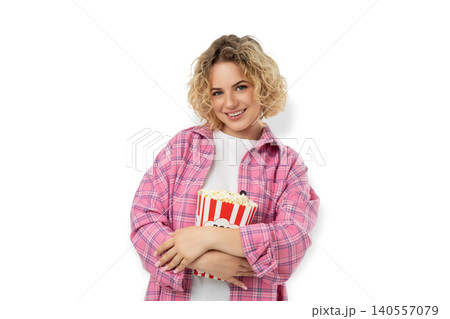 Young woman smiles while holding popcorn in bucket, PNG Young woman smiles while holding popcorn in bucket, PNG 140557079