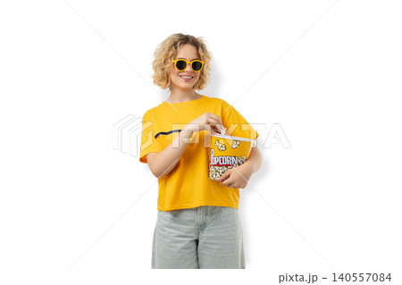 Smiling young woman holds bucket of popcorn in cinema, PNG Smiling young woman holds bucket of popcorn in cinema, PNG 140557084