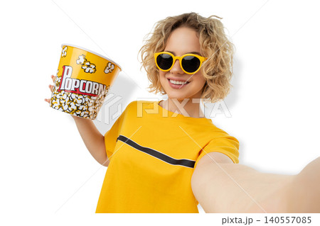 Woman holds large popcorn bucket and smiles at camera, PNG Woman holds large popcorn bucket and smiles at camera, PNG 140557085