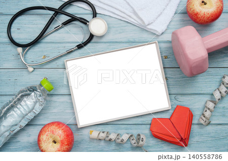 Heart health and fitness concept with stethoscope and exercise equipment Heart health and fitness concept with stethoscope and exercise equipment 140558786