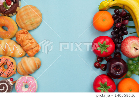 Healthy fresh fruits contrasting with unhealthy sweet pastries 140559516