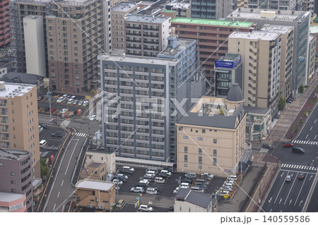 April 29 2026 Urban rooftop parking lot between city buildings April 29 2026 Urban rooftop parking lot between city buildings 140559586