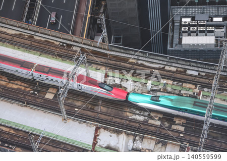 April 29 2026 Red bullet train passing through urban tracks April 29 2026 Red bullet train passing through urban tracks 140559599