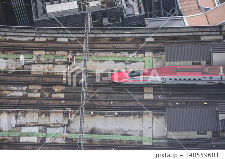 April 29 2026 Red bullet train passing through urban tracks 140559601