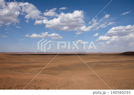 A dirt and gravel track leads towards the fine sand hills of the Merzouga Desert in Morocco. A dirt and gravel track leads towards the fine sand hills of the Merzouga Desert in Morocco. 140560293