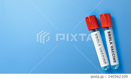 Two medical vials labeled as Ebola vaccine placed on a bright blue background, representing immunization, disease prevention, and global healthcare research Two medical vials labeled as Ebola vaccine placed on a bright blue background, representing immunization, disease prevention, and global healthcare research 140562109
