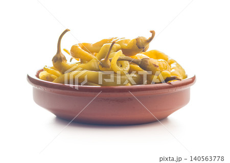 Pickled Banana Peppers in Ceramic Bowl on White Background . Tangy Yellow Appetizer and Condiment Pickled Banana Peppers in Ceramic Bowl on White Background . Tangy Yellow Appetizer and Condiment 140563778