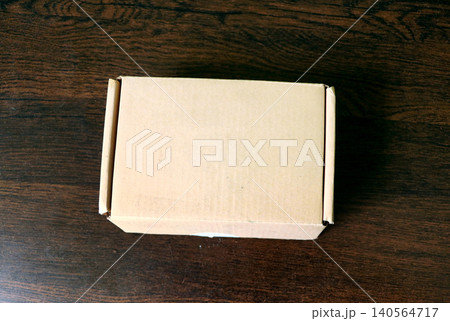 Blank Cardboard Shipping Box on Wooden Surface Blank Cardboard Shipping Box on Wooden Surface 140564717