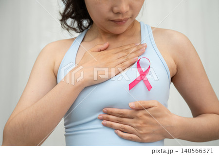 Breast cancer, pink ribbon at Asian senior lady for supporting awareness, symbol of World Breast Cancer Day. 140566371