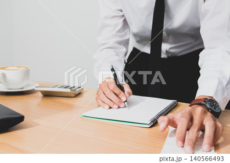 personal Businessman writing report finance, tax, calculate accounting, data on paperwork. 140566493