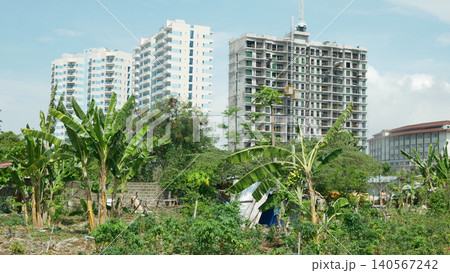 Land grabbing high rise building constructed modern condo towers construction houses land juxtaposition commercial and residential area over populated population cluster of building and houses urban Land grabbing high rise building constructed modern condo towers construction houses land juxtaposition commercial and residential area over populated population cluster of building and houses urban 140567242
