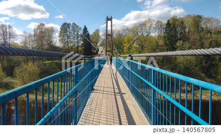 A bridge over a river with a blue railing A bridge over a river with a blue railing 140567805