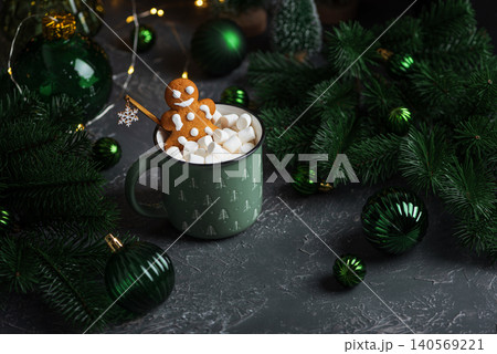 Gingerbread man decorating hot cocoa with marshmallows for Christmas Gingerbread man decorating hot cocoa with marshmallows for Christmas 140569221