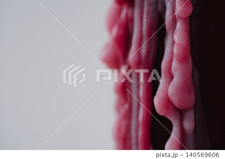 Closeup of melted red wax texture on light background Closeup of melted red wax texture on light background 140569606