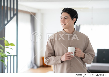 リビングで朝コーヒーを飲む男性 リビングで朝コーヒーを飲む男性 140569817