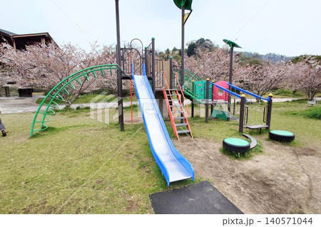 桜に囲まれた公園のすべり台とアスレチック遊具 桜に囲まれた公園のすべり台とアスレチック遊具 140571044