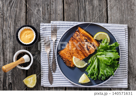 Salmon fillet grilled dinner on wooden background Salmon fillet grilled dinner on wooden background 140571631