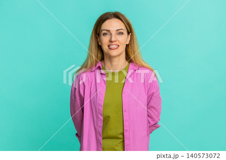 Woman sticking out tongue teasing with playful expression showing fun joke or mild mocking gesture Woman sticking out tongue teasing with playful expression showing fun joke or mild mocking gesture 140573072