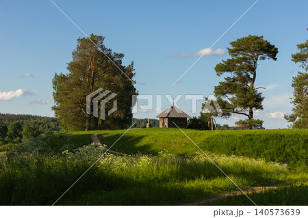 A countryside scene featuring a small historic wooden chapel A countryside scene featuring a small historic wooden chapel 140573639