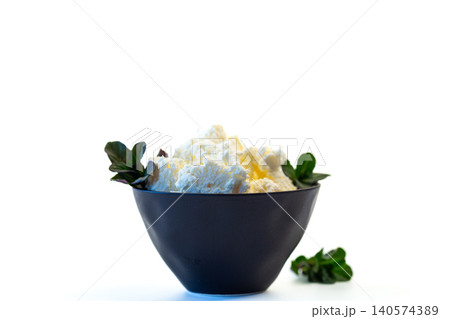 fresh homemade cottage cheese served in black bowl 140574389