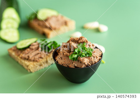 homemade liver pate on bread with green background homemade liver pate on bread with green background 140574393