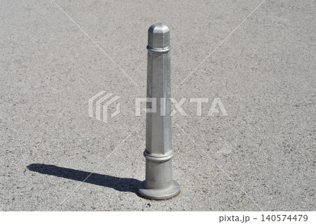 Silver Metal Traffic Bollard on Asphalt Street Silver Metal Traffic Bollard on Asphalt Street 140574479
