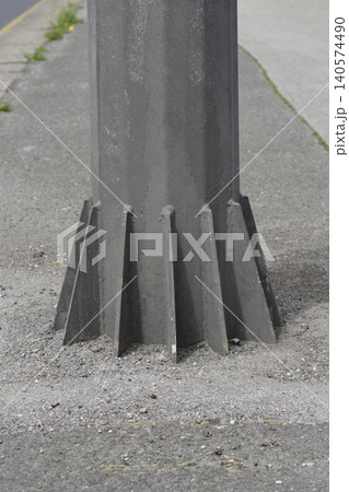 Metal Pole Base with Reinforcement Gussets on Sidewalk Metal Pole Base with Reinforcement Gussets on Sidewalk 140574490