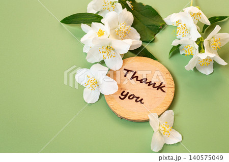 wooden thank you sign with jasmine flowers composition 140575049