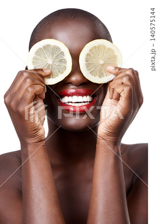Black woman, smile and lemon skincare in studio in organic dermatology routine or wellness. White background, face and happy African model with facial fruit, diet food and eyes product for beauty 140575144